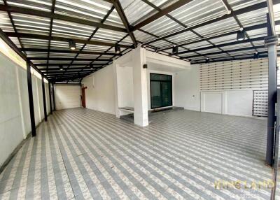 Spacious covered garage or patio area with tiled flooring