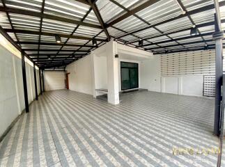 Spacious covered garage or patio area with tiled flooring