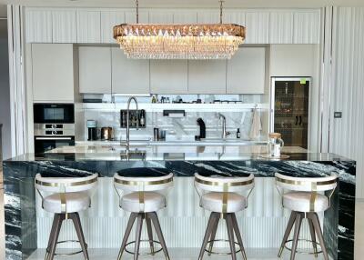 Modern kitchen with marble island and bar stools