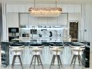 Modern kitchen with marble island and bar stools