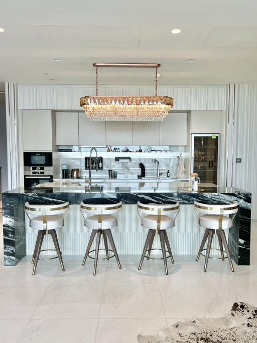 Modern kitchen with marble island and bar stools