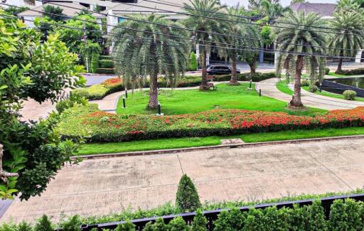 Beautifully landscaped garden with palm trees and vibrant flowers