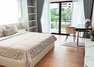 Spacious bedroom with large windows and modern furnishings