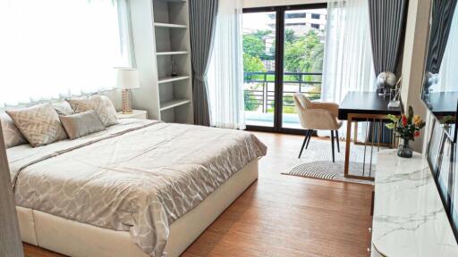 Spacious bedroom with large windows and modern furnishings