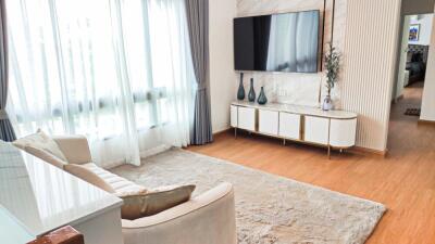 Bright and modern living room with a TV and decorative items