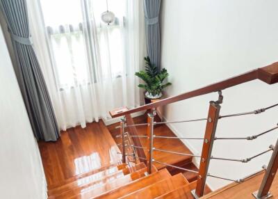 Modern staircase with wooden steps and metal railing