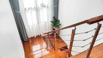 Modern staircase with wooden steps and metal railing