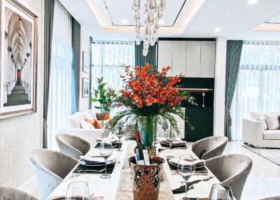 Elegant dining room with a set table, chic décor, and contemporary lighting