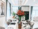 Elegant dining room with a set table, chic décor, and contemporary lighting