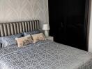 Modern bedroom with patterned bedding and textured wallpaper