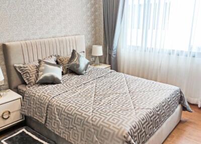 Modern bedroom with patterned wallpaper and grey decor