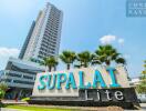 Exterior view of Supalai Lite condominium with a tall building in the background