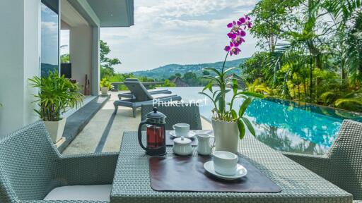 Outdoor patio with pool and mountain view