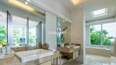 Modern bathroom with dual sinks and large mirrors