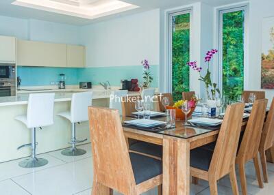 Modern dining area with a view of the fully equipped kitchen