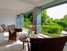 spacious balcony with outdoor furniture and lush green view