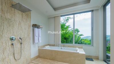 modern bathroom with a bathtub and large window