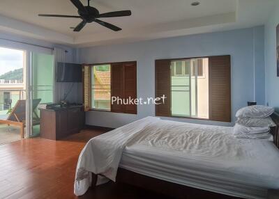 Spacious bedroom with large windows and outdoor access