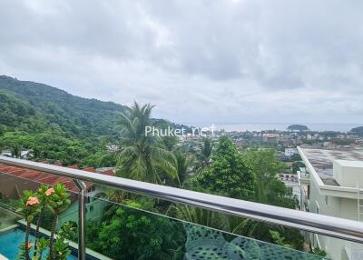 balcony with a view of hills and town