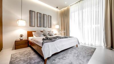 Modern bedroom with large windows and natural light