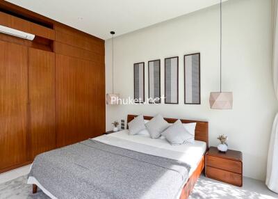 Modern bedroom with wooden furniture and contemporary decor.