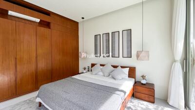 Modern bedroom with wooden furniture and contemporary decor.