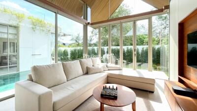 Spacious living room with large windows and modern furniture