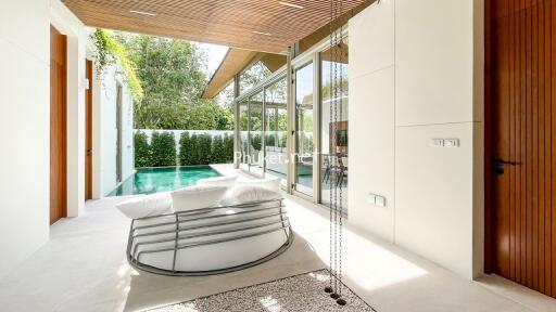 Outdoor living area with modern furniture and private pool