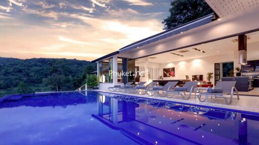 Luxurious home with a stunning outdoor pool area at sunset