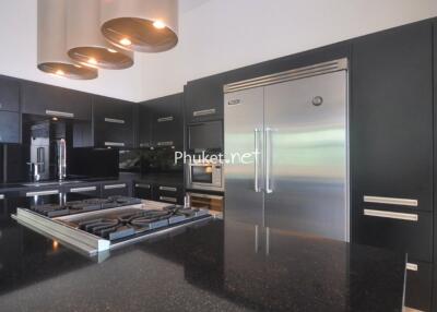 Modern kitchen with black cabinetry and stainless steel appliances