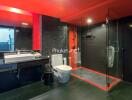 Modern bathroom with red ceiling and black tiles