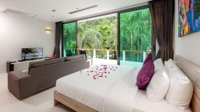 Spacious bedroom with large window and garden view