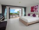 Modern bedroom with a large bed and balcony view