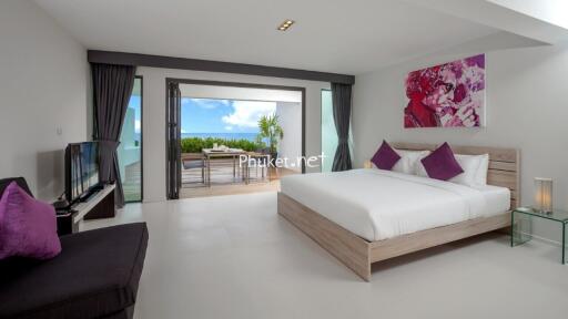 Modern bedroom with a large bed and balcony view