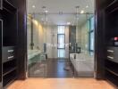 Modern bathroom with glass doors, large mirrors, and built-in storage