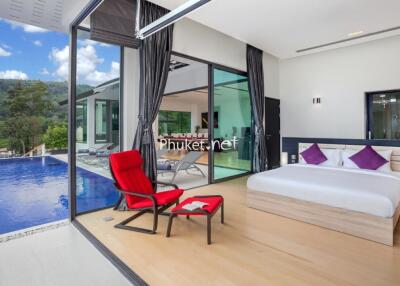 Modern bedroom with a pool view and outdoor seating