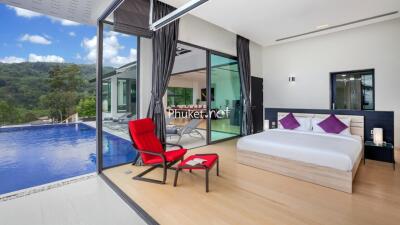 Modern bedroom with a pool view and outdoor seating