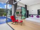 Modern bedroom with a pool view and outdoor seating