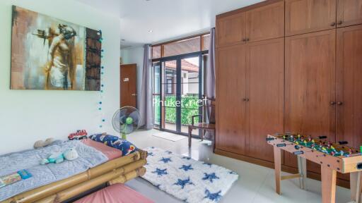 Cozy bedroom with large window and wooden wardrobe