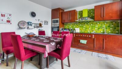 Modern kitchen with wooden cabinets and dining area