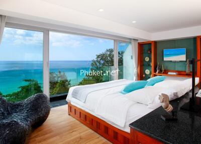 Spacious beachfront bedroom with large windows and modern decor