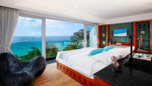 Spacious beachfront bedroom with large windows and modern decor