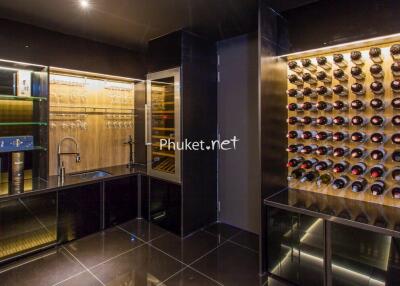 Modern wine cellar with glass display shelves and extensive wine bottle storage