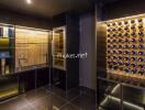 Modern wine cellar with glass display shelves and extensive wine bottle storage