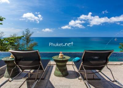 Beachfront outdoor area with lounge chairs and infinity pool