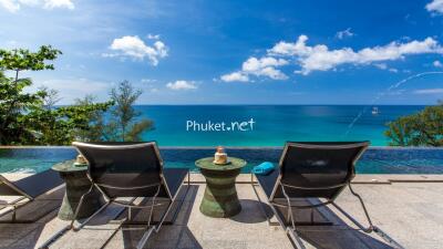 Beachfront outdoor area with lounge chairs and infinity pool