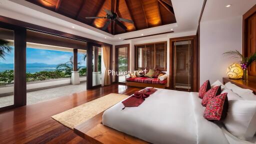 Spacious bedroom with large windows and ocean view