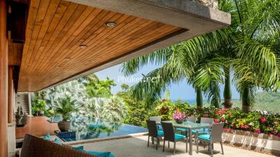 Outdoor patio with dining area, pool, and ocean view