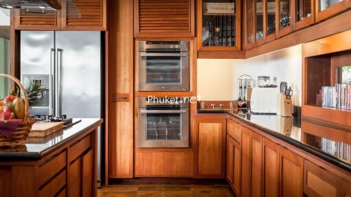 Modern kitchen with wooden cabinets and stainless steel appliances