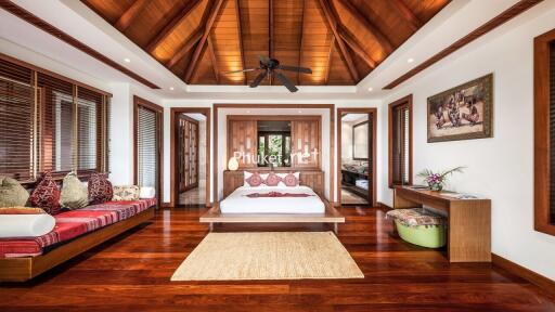 Spacious and luxurious bedroom with wooden ceiling and flooring